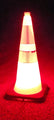 FLAIRR Guardian electronic road flare placed under a 28-inch tall traffic cone, completely illuminating the entire safety cone structure from within.